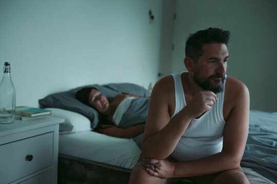 Unhappy couple at home in bed