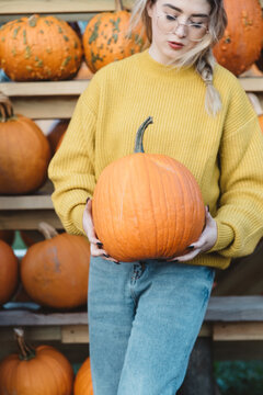 A young woman at a pumpkin patch