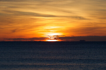 Spring Sunrise over the Pacific ocean in Chiba Japan. An amazing orange glow with wispy clouds makes this a beautiful background image.