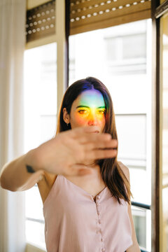 Woman with rainbow face protesting against photo