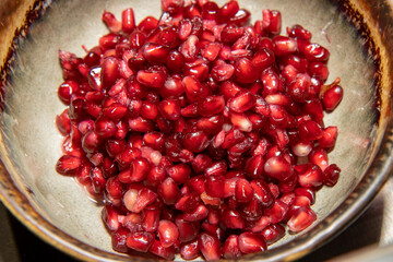 A bowl of pomegranate seeds ready to be used in cooking or on a salad