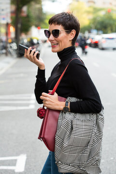 Stylish short haired business woman commuting between meetings on a busy city