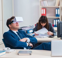 Employee with virtual reality glasses in office