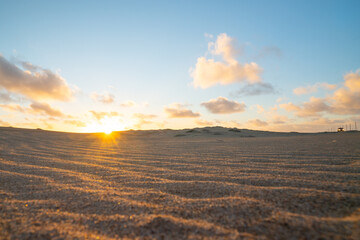 Sand dunes on the beach at sunset, California