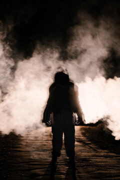 Spaceman standing in smoke