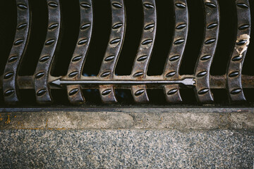 Arrows in street sewer cap.