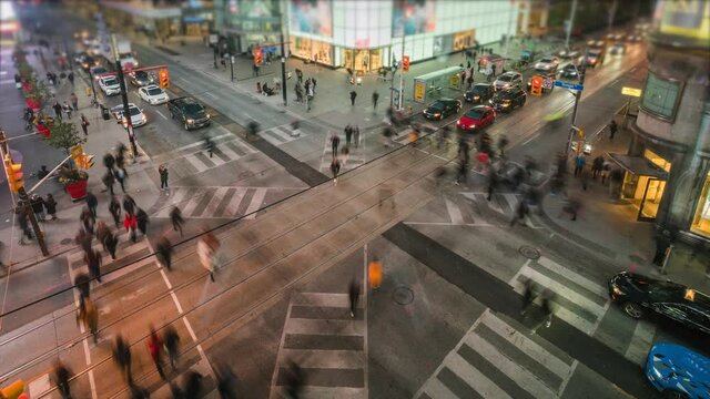 Toronto, Ontario, Canada, time lapse view of traffic and pedestrians crossing busy intersection at Yonge and Dundas Square.