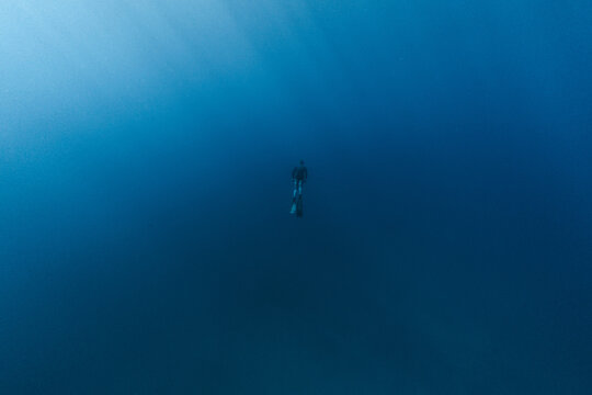Person freediving in blue water