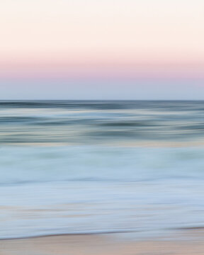 Motion blur of ocean at sunrise