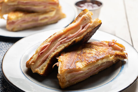 Ham and melted cheese sandwich called Monte Cristo on white background