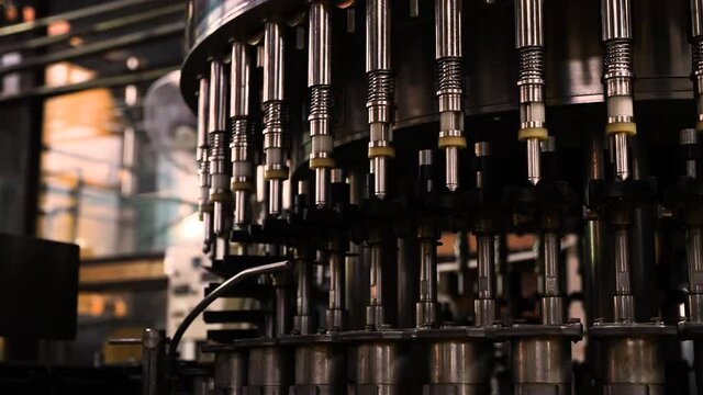 Close up shot of automatic beverage filling machine starting progress warm up, Industrial Factory back to rerun business. 