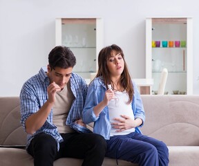 Pregnant woman with husband at home