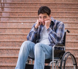 Disabled man on wheelchair having trouble with stairs