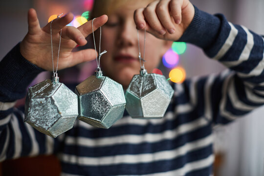 Child holding Christmas decorations