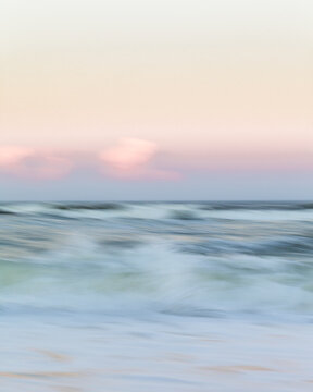 Abstract motion blur of crashing waves at sunrise