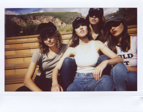 Stylish millennials posing together on polaroid