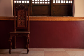 Interior of a traditional,  vintage and old fashion ancestral house with locally hand made chair and windows 