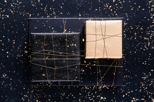 black and gold gifts with glitter on black background