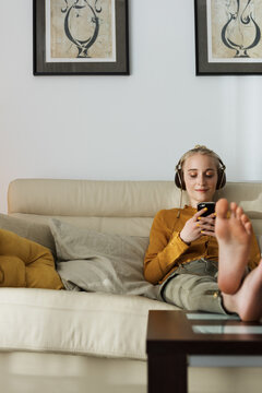 Casual woman lounging with music
