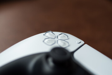 Closeup of a white modern video games controller on a table 