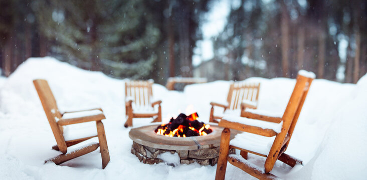 Firepit and chairs in a snowy setting in winter