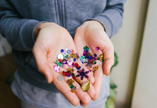 Girl Holding Glittering Confetti on her Hands.