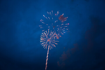 Colorful fireworks celebration at night with dark blue sky