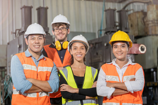 group worker factory men and women standing with confidence and success. people working in workplace of industrial heavy machine factory. young adult in career of industry of technology machinery.