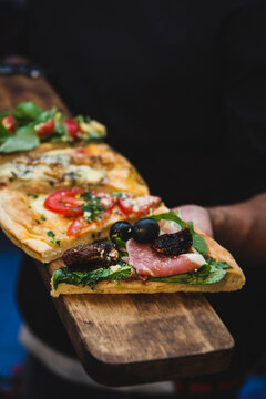 Pizza portions over wood for serve