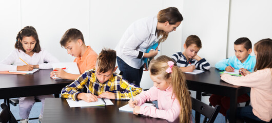 Little children with their teacher in a classroom