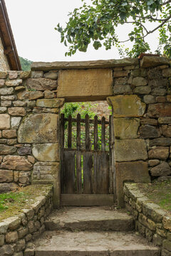 Old wooden fence on a rustic stone wall