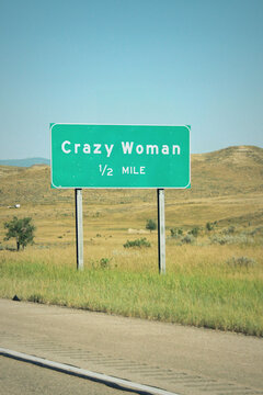 Crazy Woman in 1/2 mile road sign