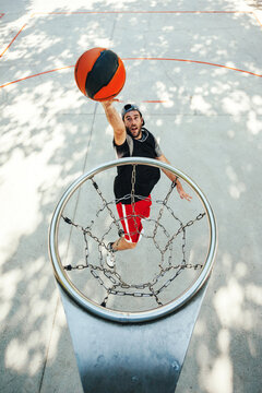 Aerial view of a basketball players training on outdoors court.