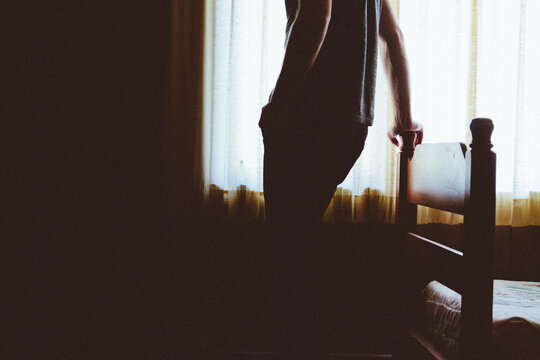 Silhouette of a man in bedroom