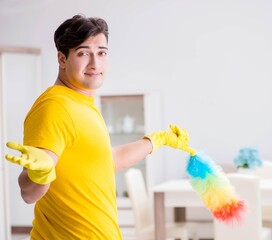 Man husband cleaning the house helping his wife