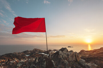 Waving red flag in a cliff.