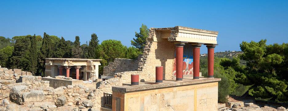 The North Portico in Knossos, Crete, Greece. Bronze age excavations of Knossos town on the greek island of Crete. Panoramic banner image with blue sky.