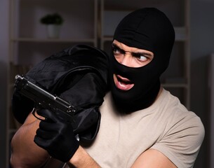 Burglar wearing balaclava mask at crime scene