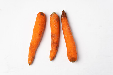 Rotten carrots on white background