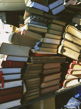 Stack of old books for sale on the street at book market.