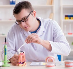 Dentist working teeth implant in medical lab