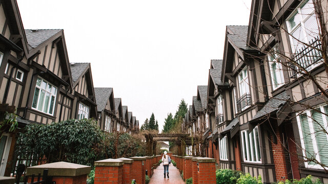 Lady walking past a row of houses