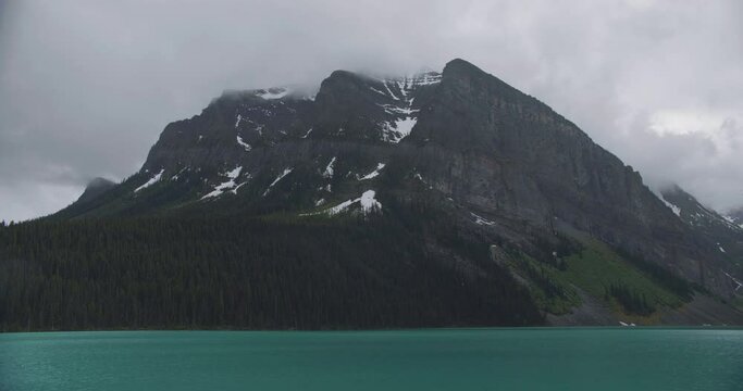 Large mountains with very steep and stunning rocks located on the bank of a small river. An indescribable mountainscape and river nearby