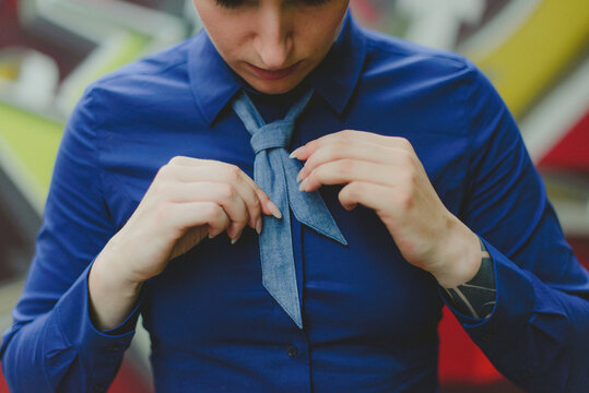 a woman binding a short tie