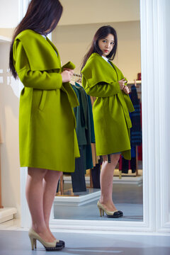 young asian woman wearing new cloth in the shop