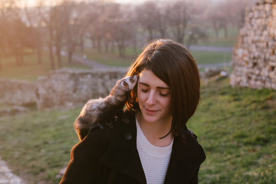 Young Brunette Woman With Pet Ferret