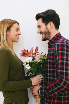 Young couple in love holding a bouquet of flowers on Valentine's day.