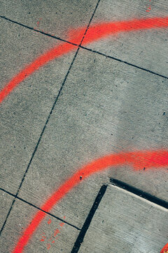 Red spray paint on urban sidewalk