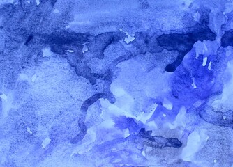 Blue watercolor background. Transparent lines and spots on a white paper background. Paint leaks and ombre effects. Abstract hand-painted image. © Olirina