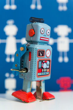 A vintage wind up toy robot, painted in blue and red